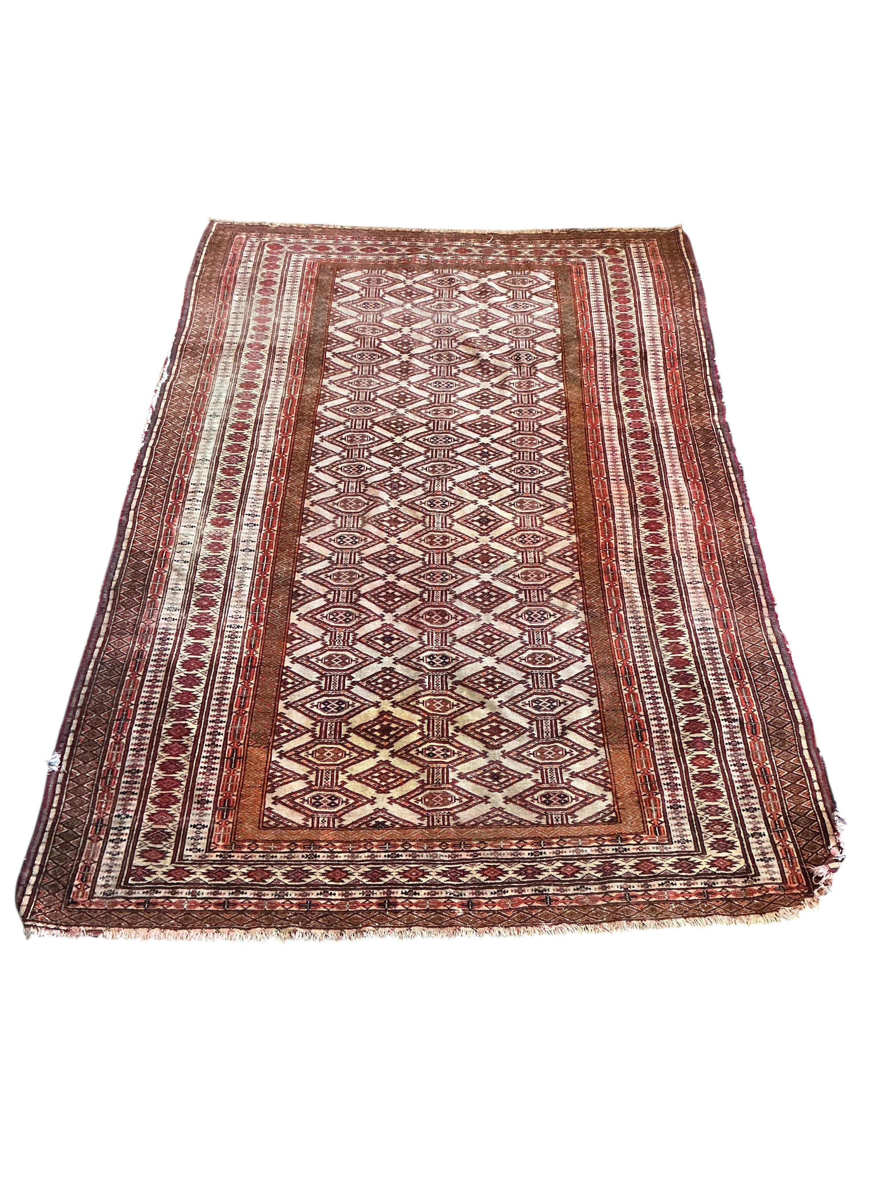 An Afghan red ground rug, 184 x 126cm